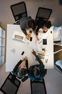 workers at a desk from above